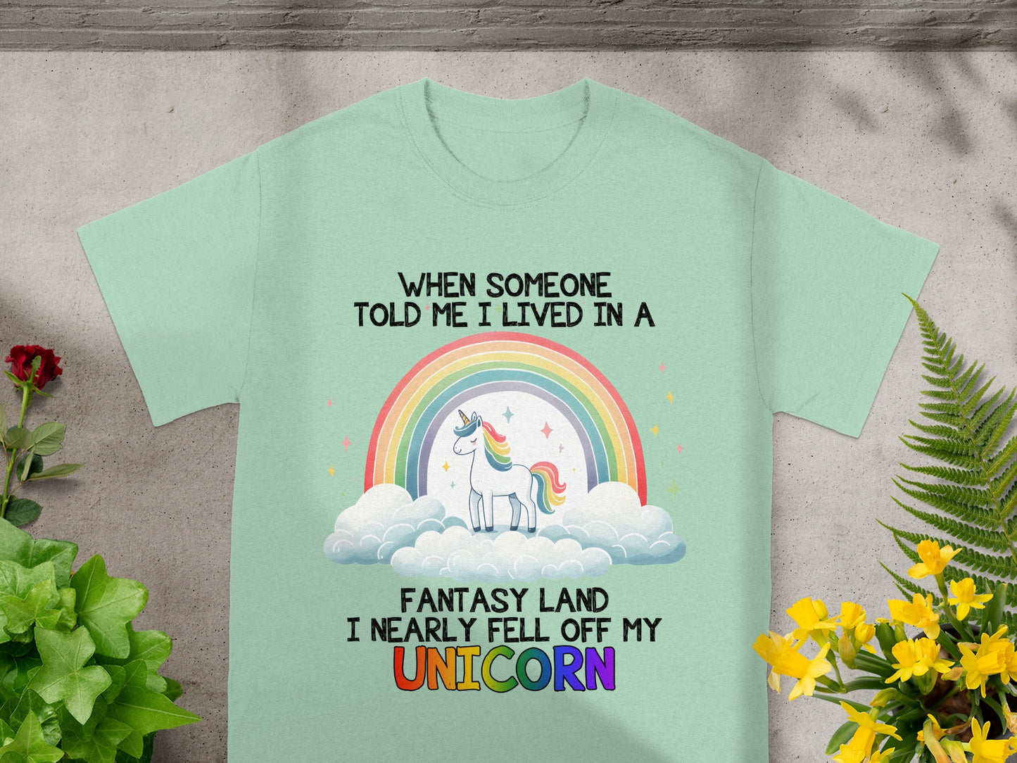 Mint t-shirt with "When someone told me I lived in a fantasy land I nearly fell off my Unicorn" text and artwork.