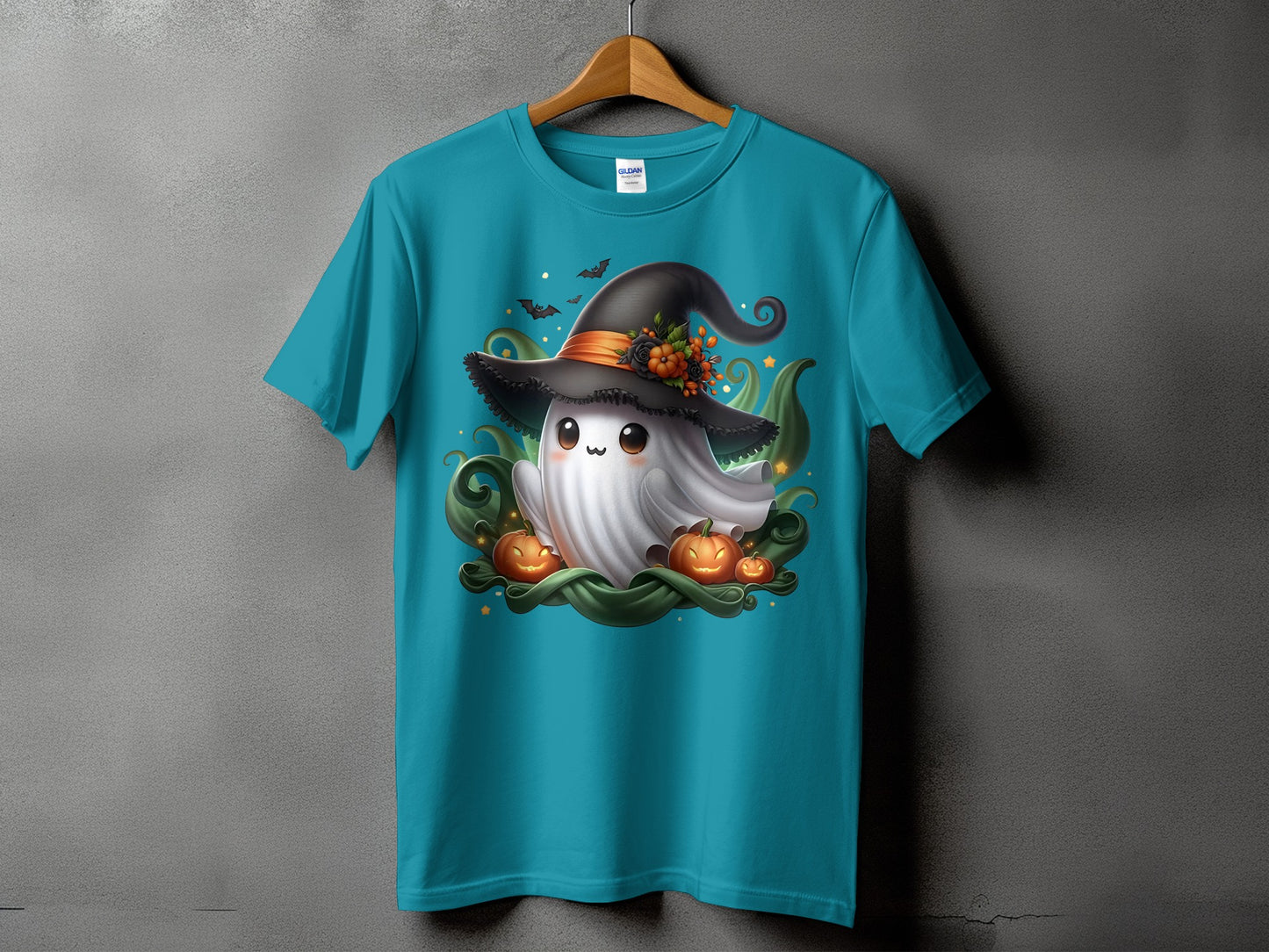 Turquoise t-shirt with a ghost wearing a witch hat and surrounded by pumpkins.