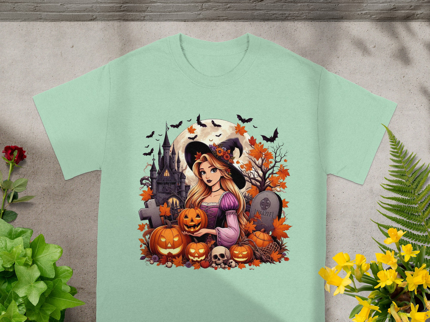 Cartoon witch with pumpkins, skulls, bats, and a castle on a t-shirt.
