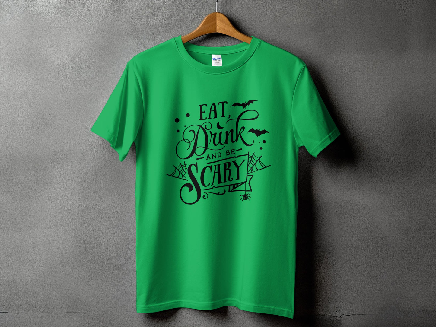 Green t-shirt with black Halloween graphic reading "Eat, Drink and be Scary."