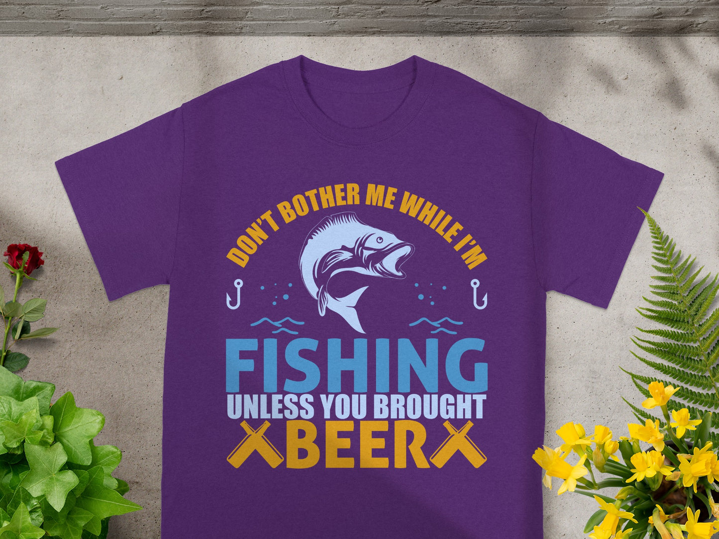 Purple t-shirt with "DON'T BOTHER ME WHILE I'M FISHING UNLESS YOU BROUGHT BEER."