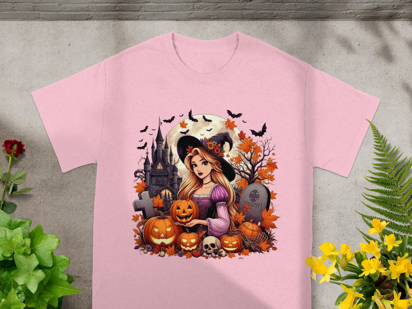 Pink t-shirt with cartoon witch, pumpkins, castle, bats, and tombstone reading "IMAZLE".