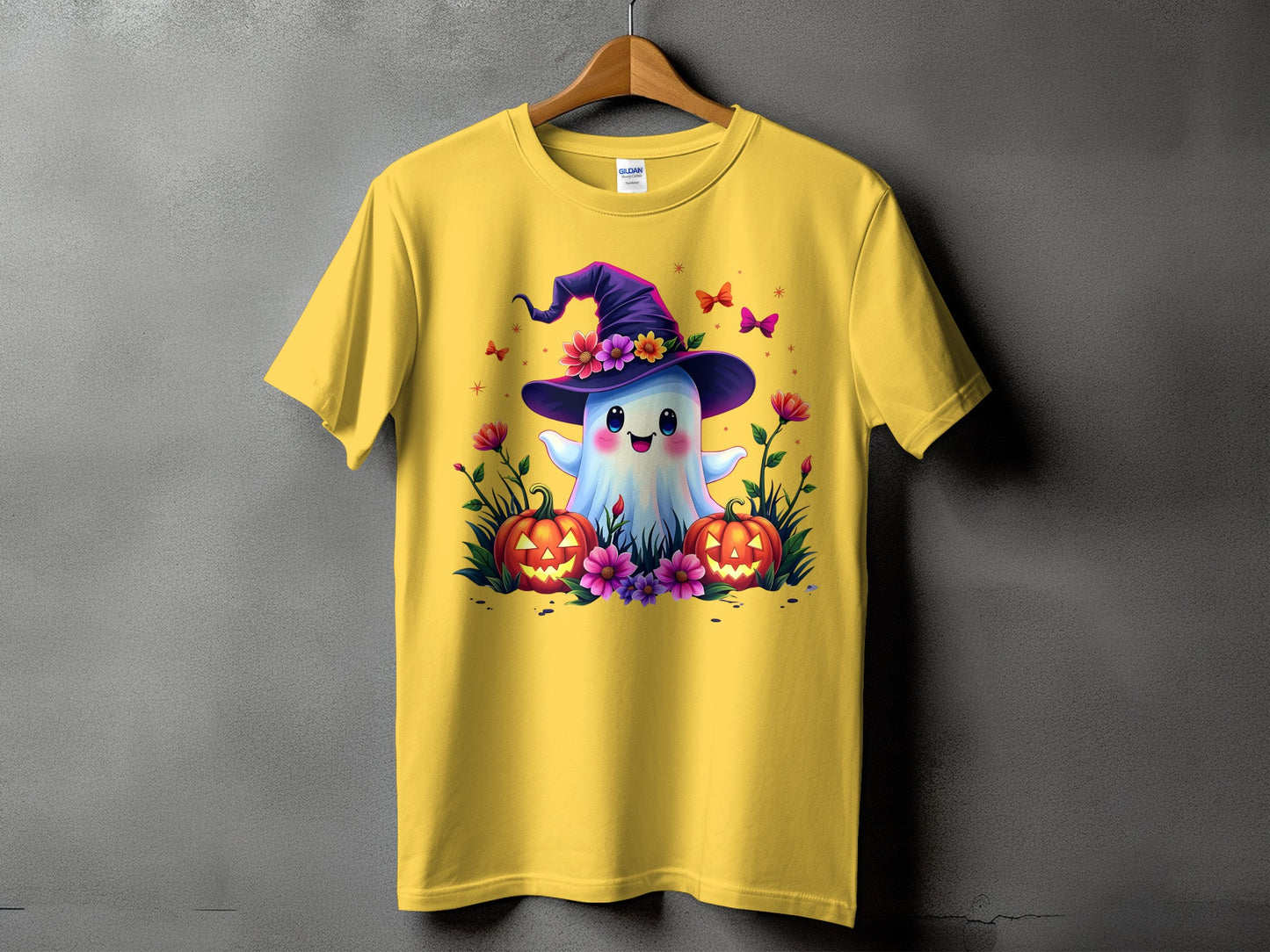 Yellow t-shirt with a cute ghost wearing a witch hat and pumpkins.