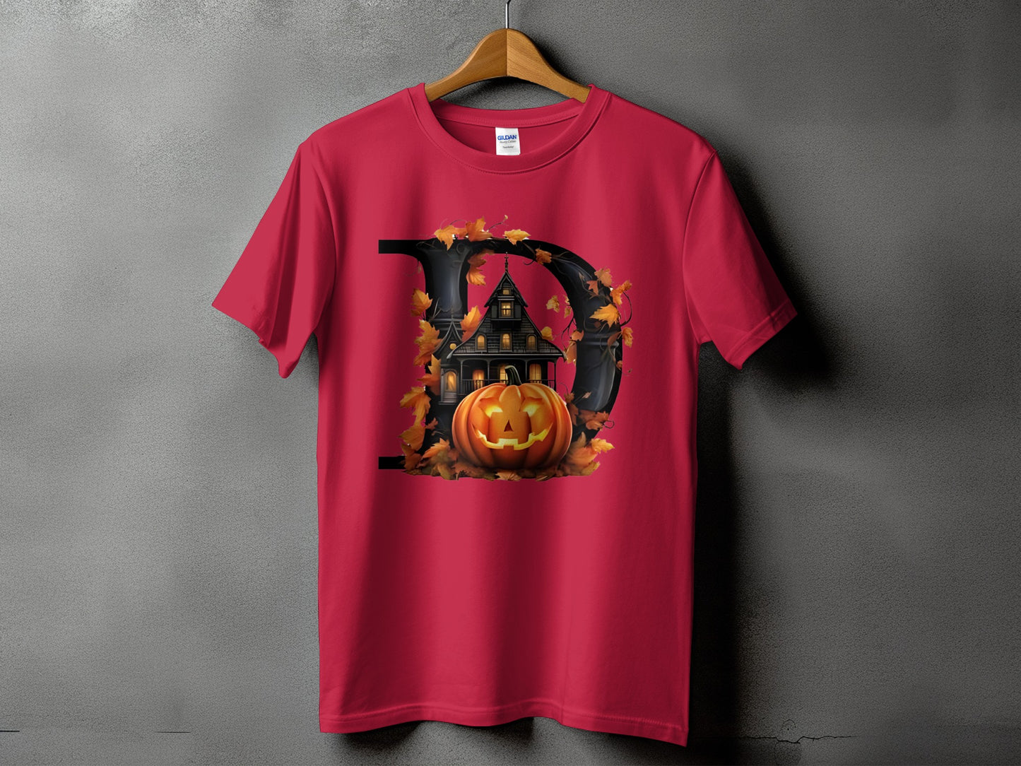 Red t-shirt with a black letter D, haunted house, and jack-o'-lantern graphic.