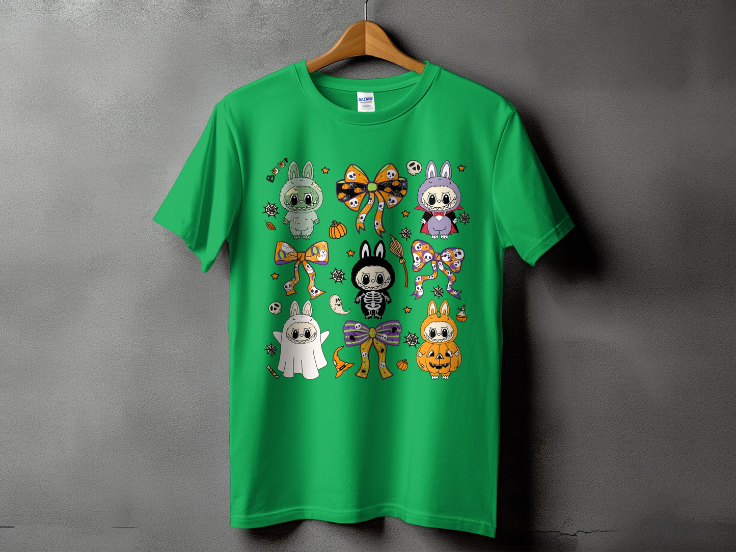 Green t-shirt with a collage of cute Halloween-themed characters and bows.