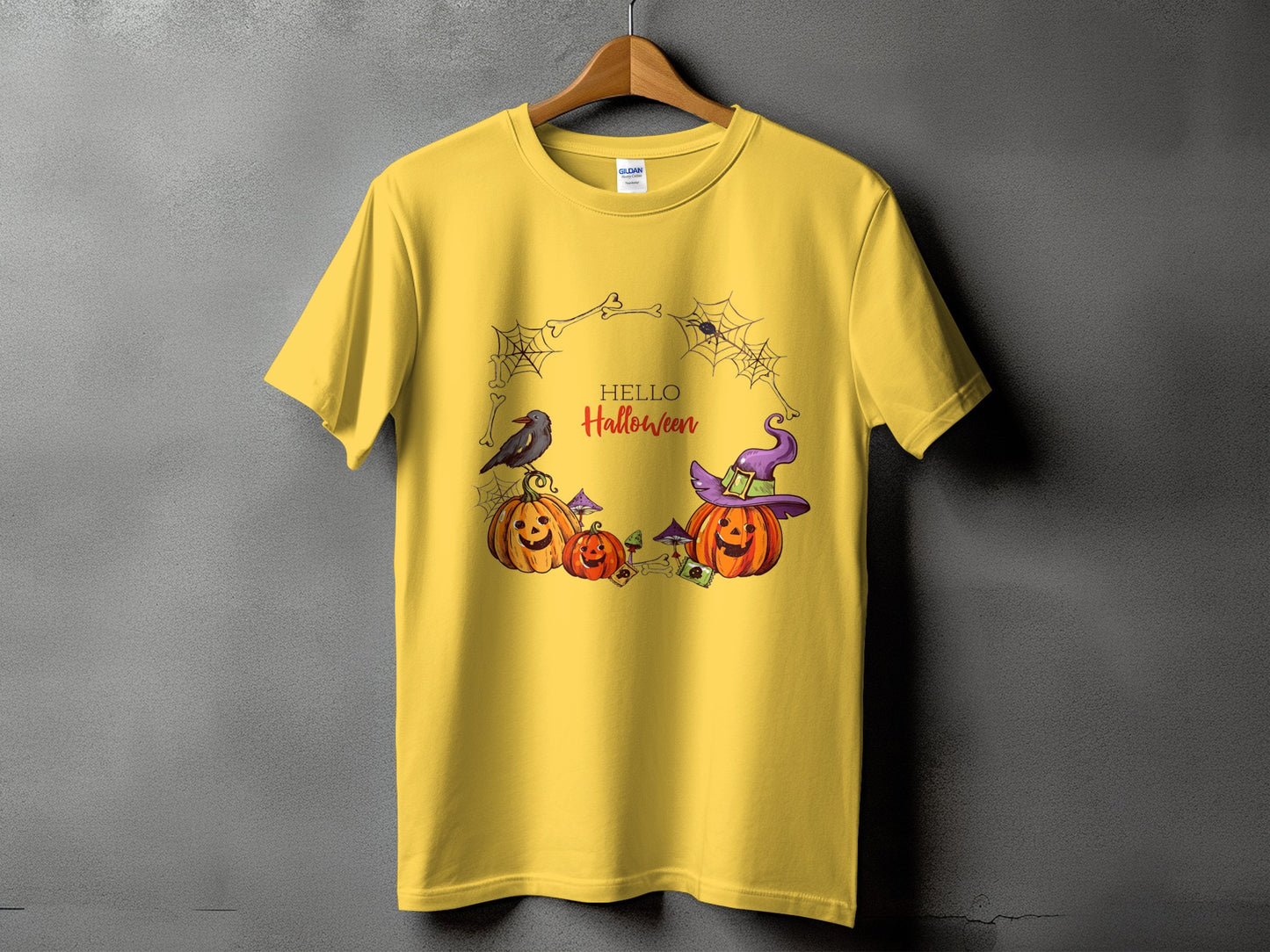 Yellow t-shirt with Halloween graphic featuring pumpkins, crow, witch hat, and text.