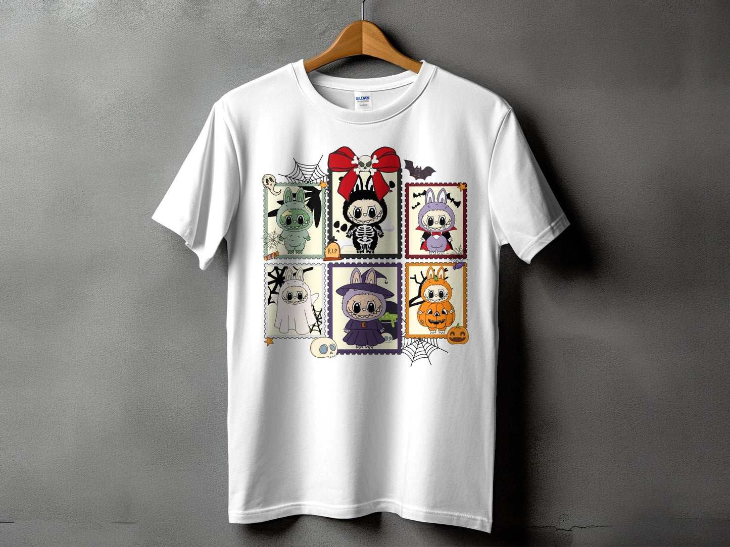 White t-shirt with six Halloween-themed cartoon stamps featuring cute monsters.