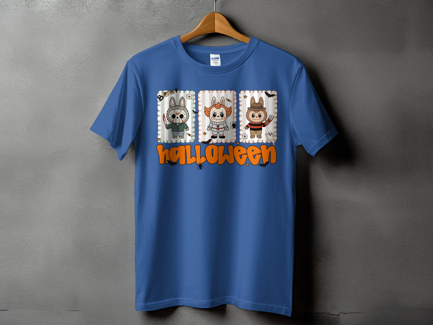 Blue t-shirt with cartoon Halloween characters and text.