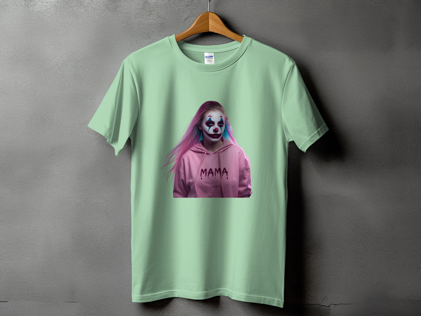 Light green t-shirt with a graphic of a person in clown makeup and a pink hoodie reading "MAMA".