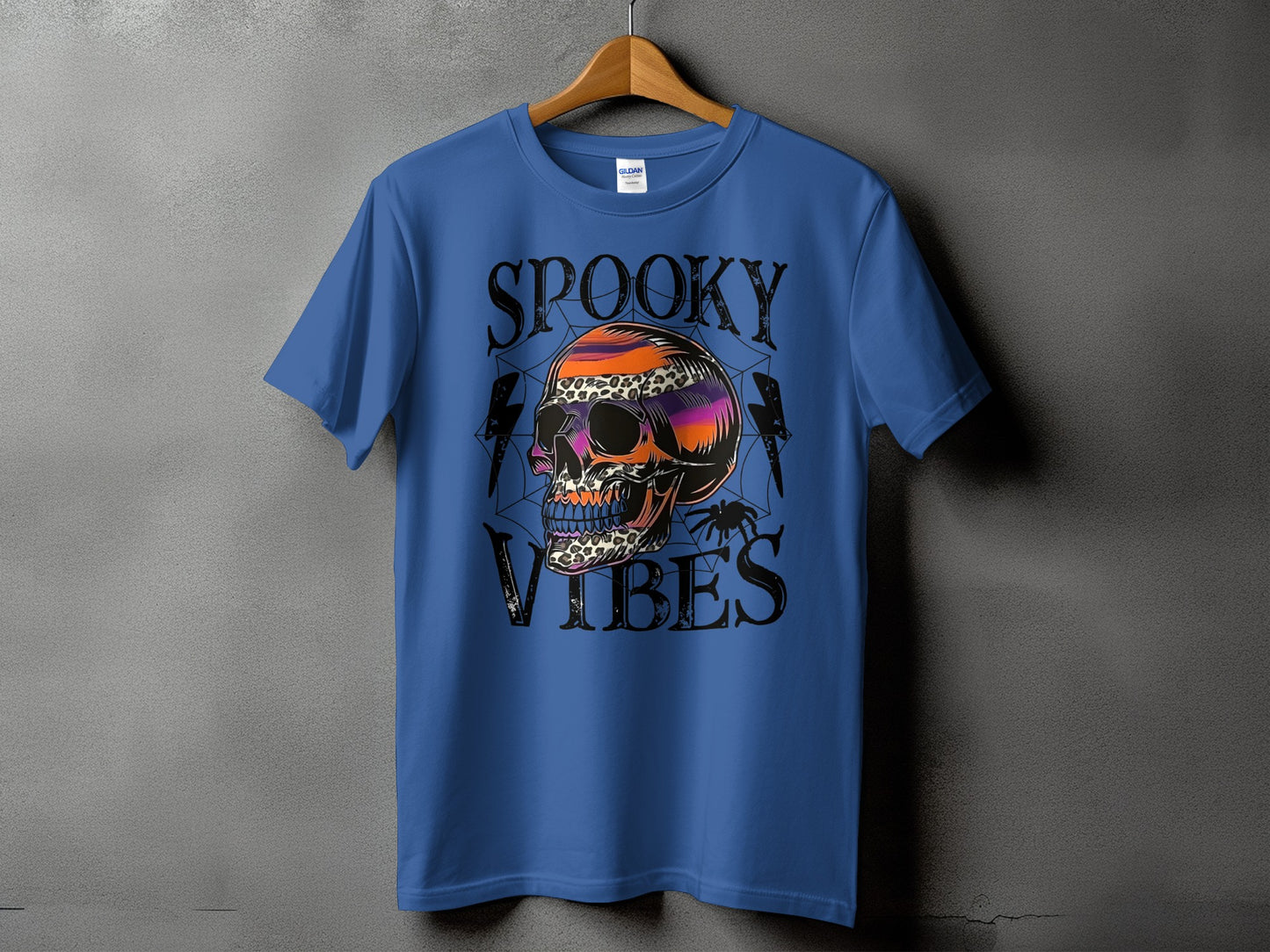Blue t-shirt with a skull graphic and the text "SPOOKY VIBES".