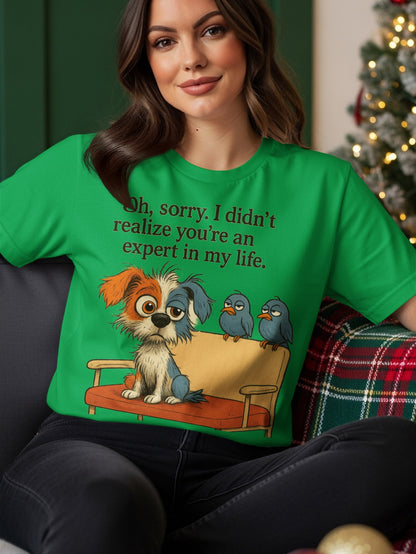 Green t-shirt with a dog and birds on a couch, text reads "Oh, sorry, I didn't realize you're an expert in my life."