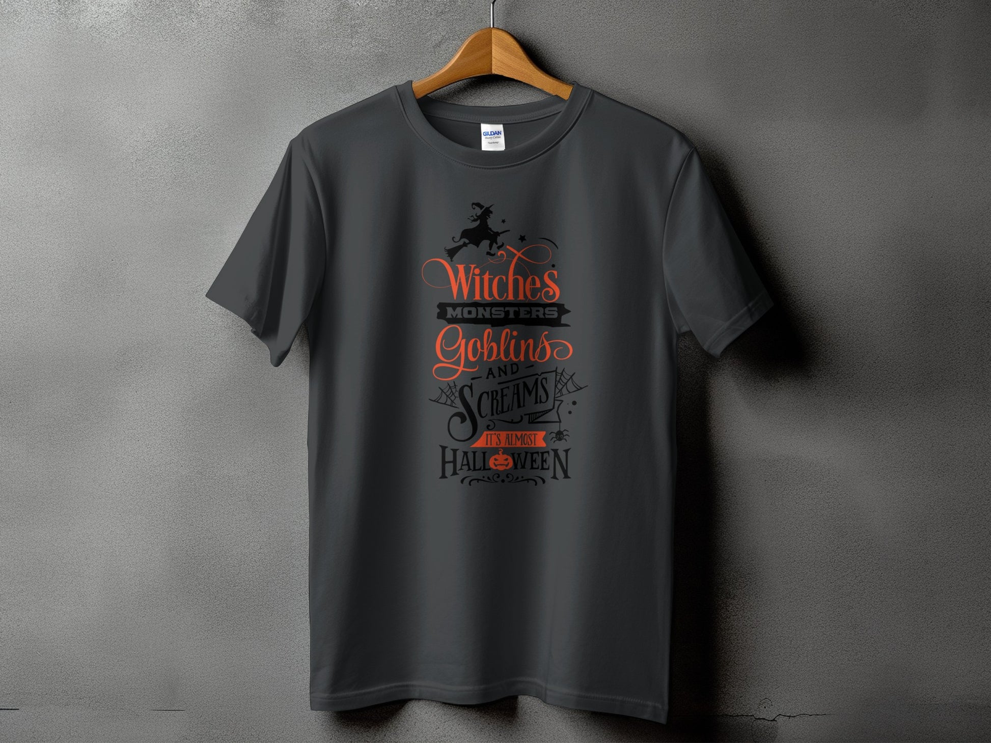 Dark grey t-shirt with text: Witches, Monsters, Goblins, and Screams. It's Almost Halloween.