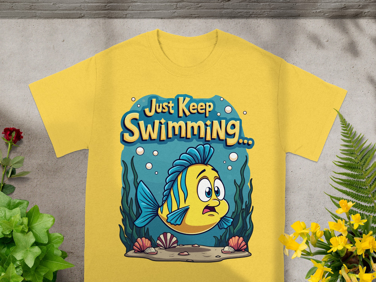 Yellow t-shirt with yellow fish graphic and text "Just Keep Swimming"