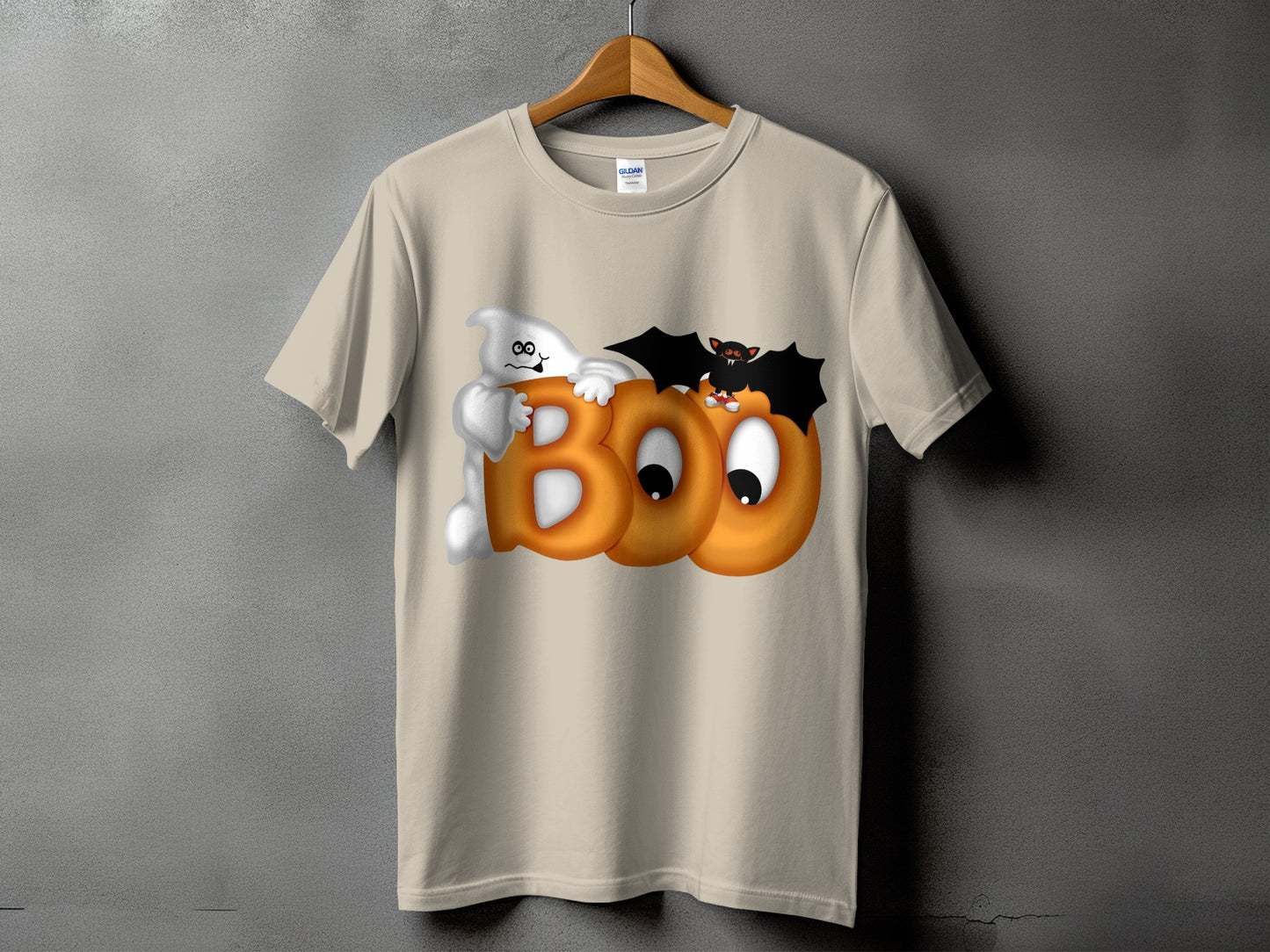Ghost and bat with "BOO" on a tan t-shirt for Halloween.