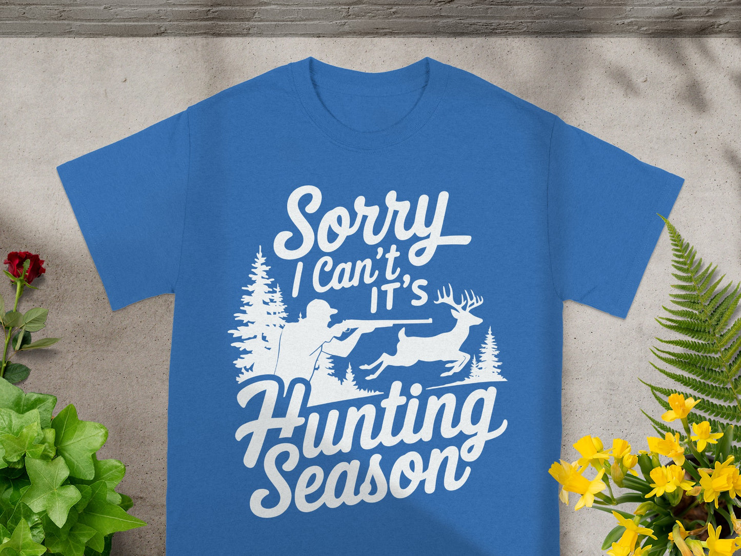 Blue t-shirt with white graphic and text saying "Sorry I Can't, It's Hunting Season".