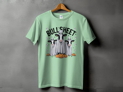 Green t-shirt with "Bull Sheet" text, cows in ghost costumes, and pumpkins.