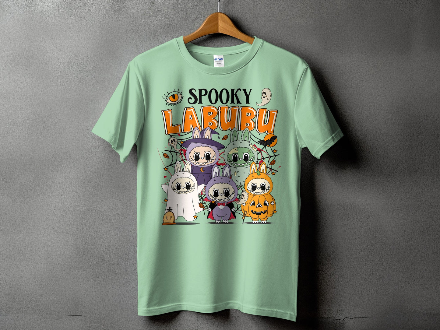 Spooky Labubu Halloween creatures in costumes on a light green t-shirt.