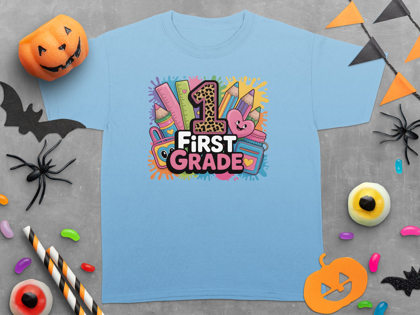 Light blue t-shirt with "1st GRADE" graphic featuring school supplies and a leopard print "1".