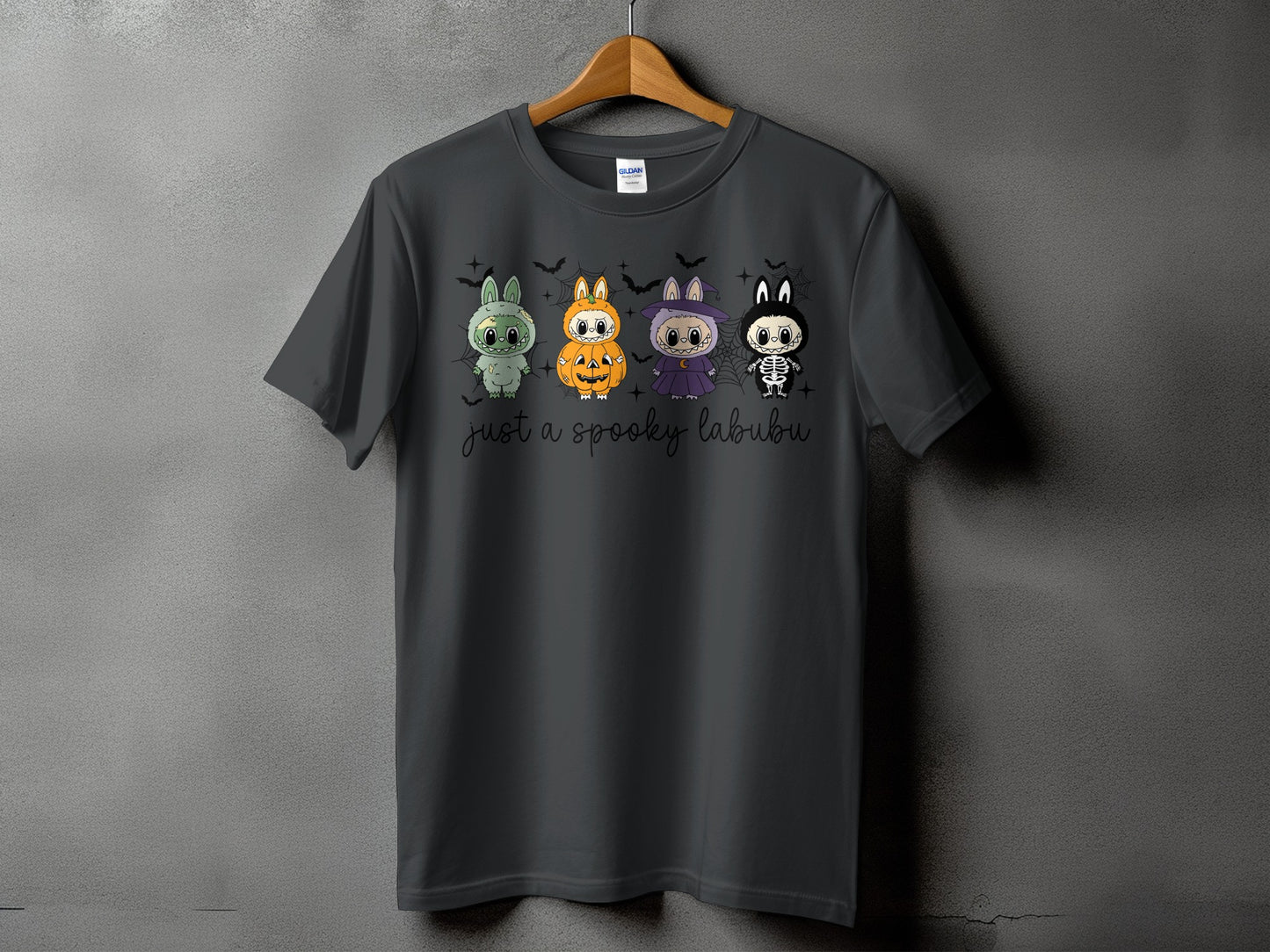Dark grey t-shirt with four spooky Halloween-themed cartoon characters and "just a spooky labubu" text.