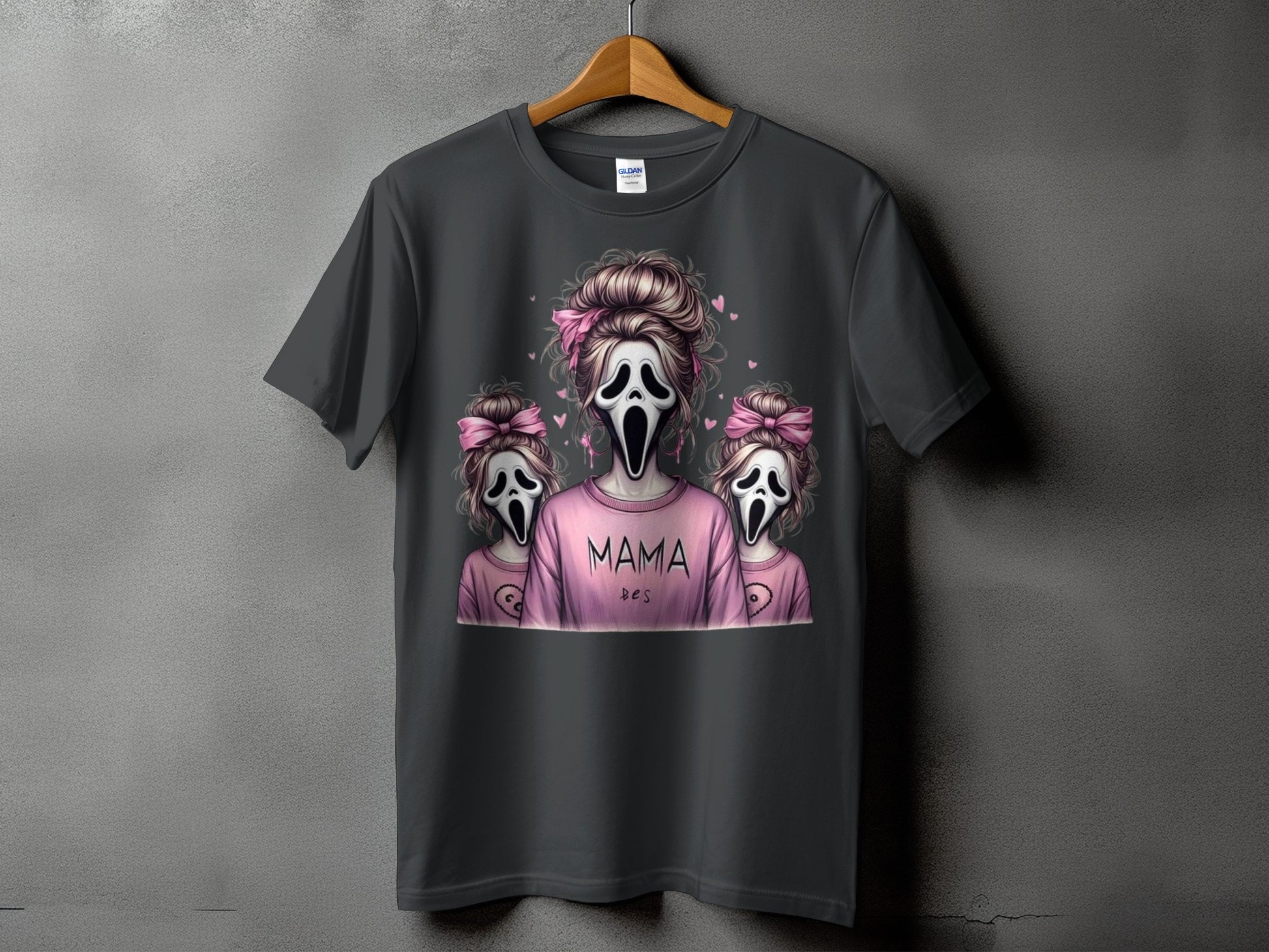 Dark t-shirt with "Mama" and two ghost figures with pink bows.