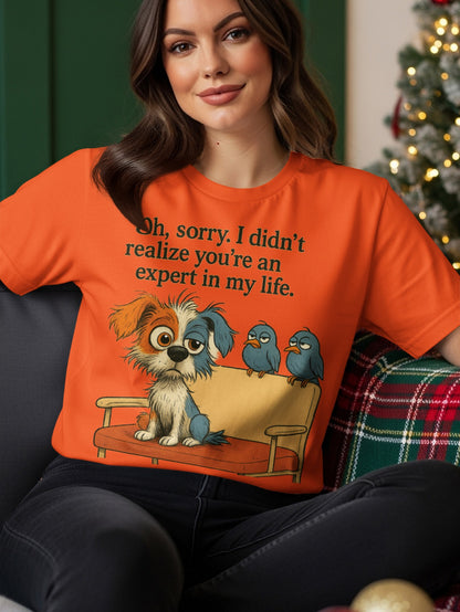 Orange t-shirt with dog and birds, text reads "Oh, sorry. I didn't realize you're an expert in my life."