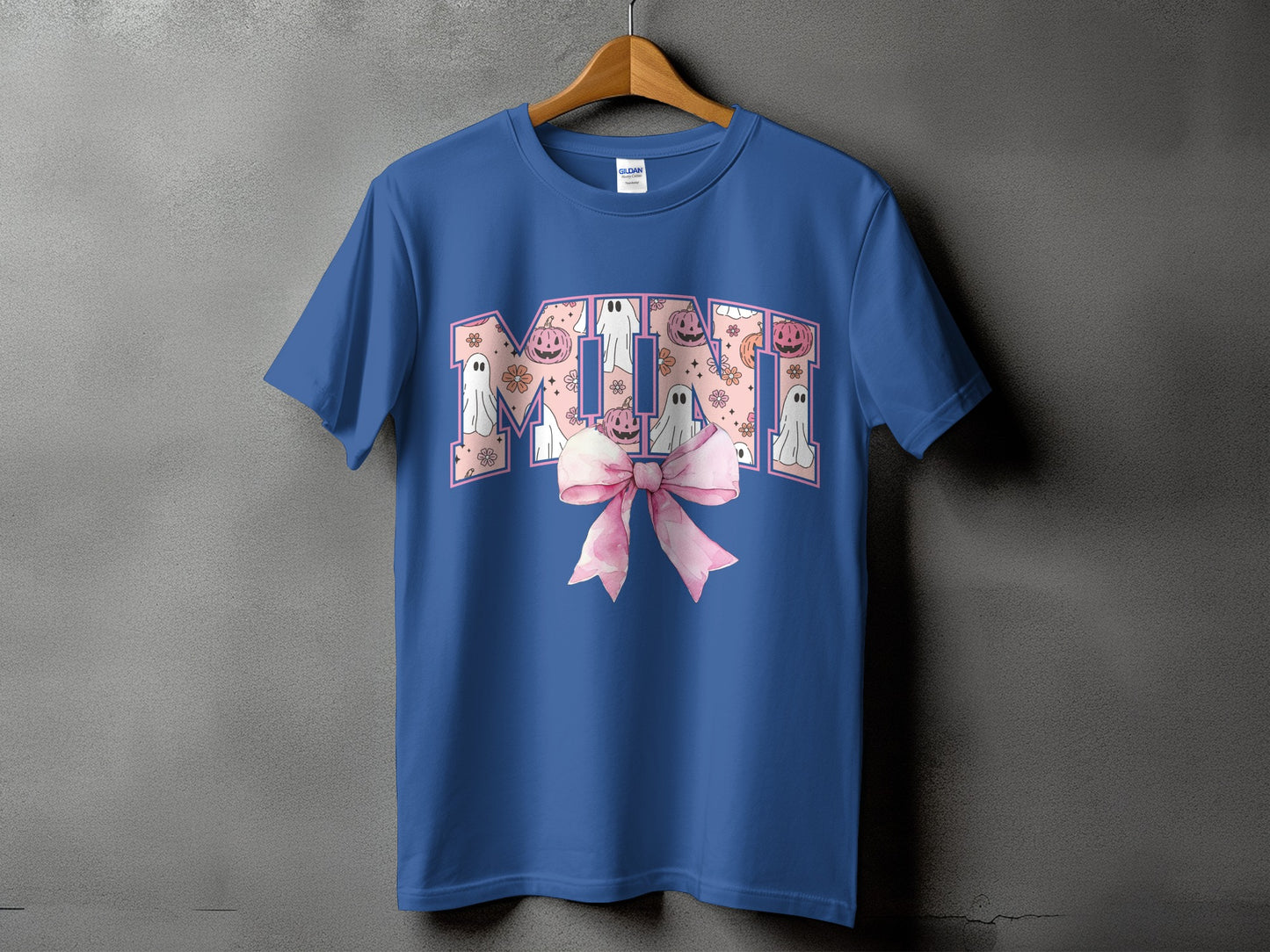 Blue t-shirt with "MIMI" in a pink Halloween-themed font and a pink bow.