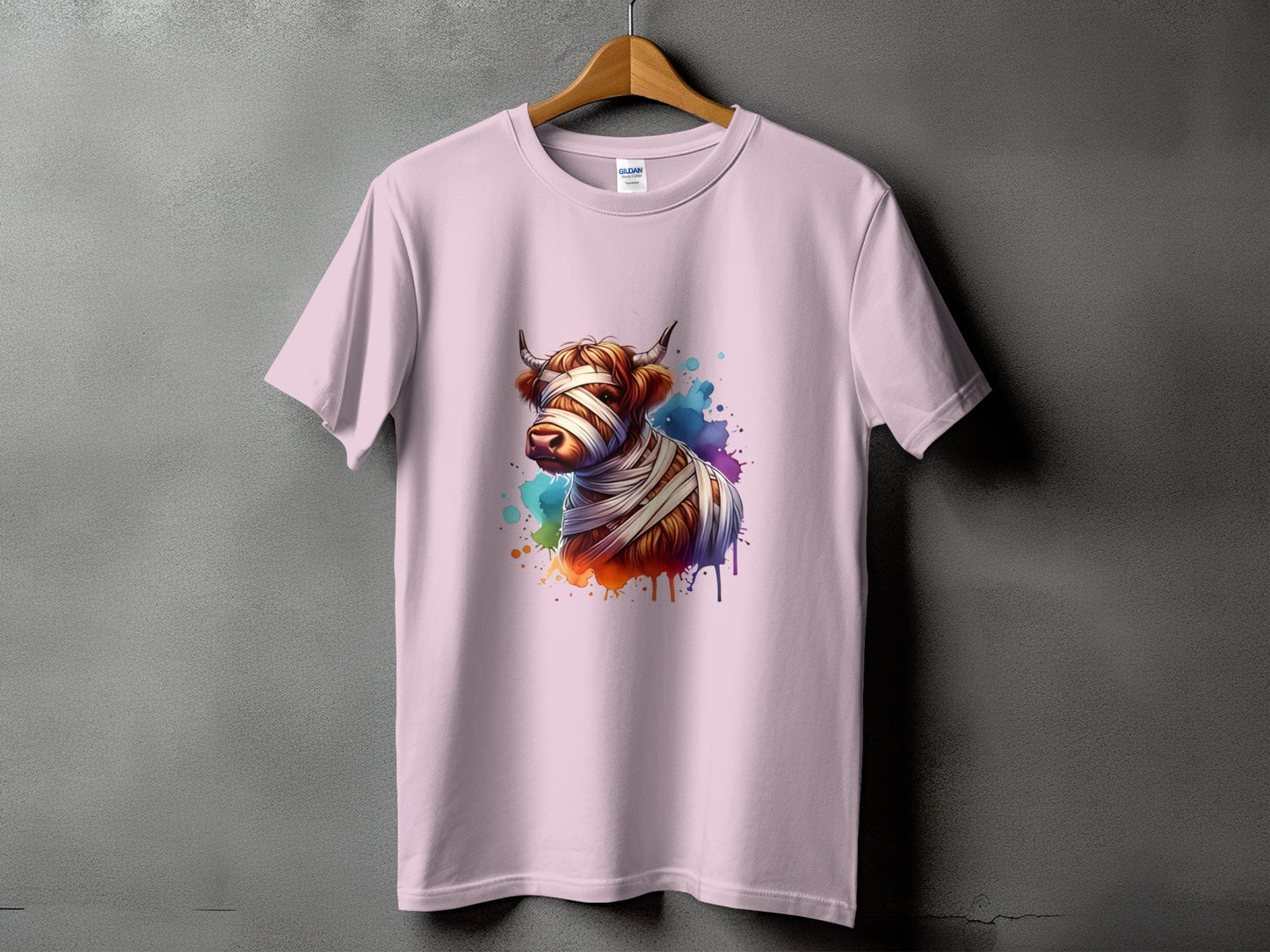 Pink t-shirt with a watercolor mummy cow graphic and colorful paint splatters.