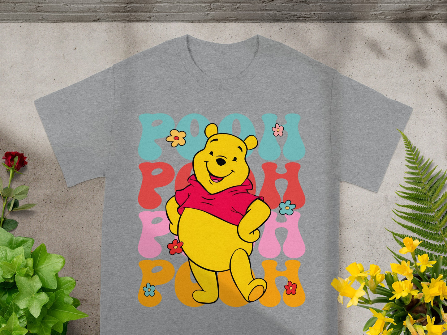 Winnie the Pooh wearing a red hoodie with colorful "POOH" text.