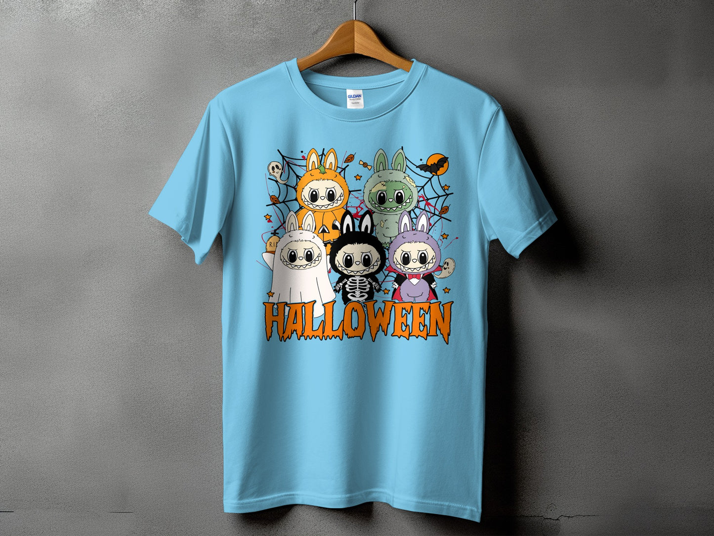 Light blue t-shirt with cartoon Halloween characters and the word "HALLOWEEN".