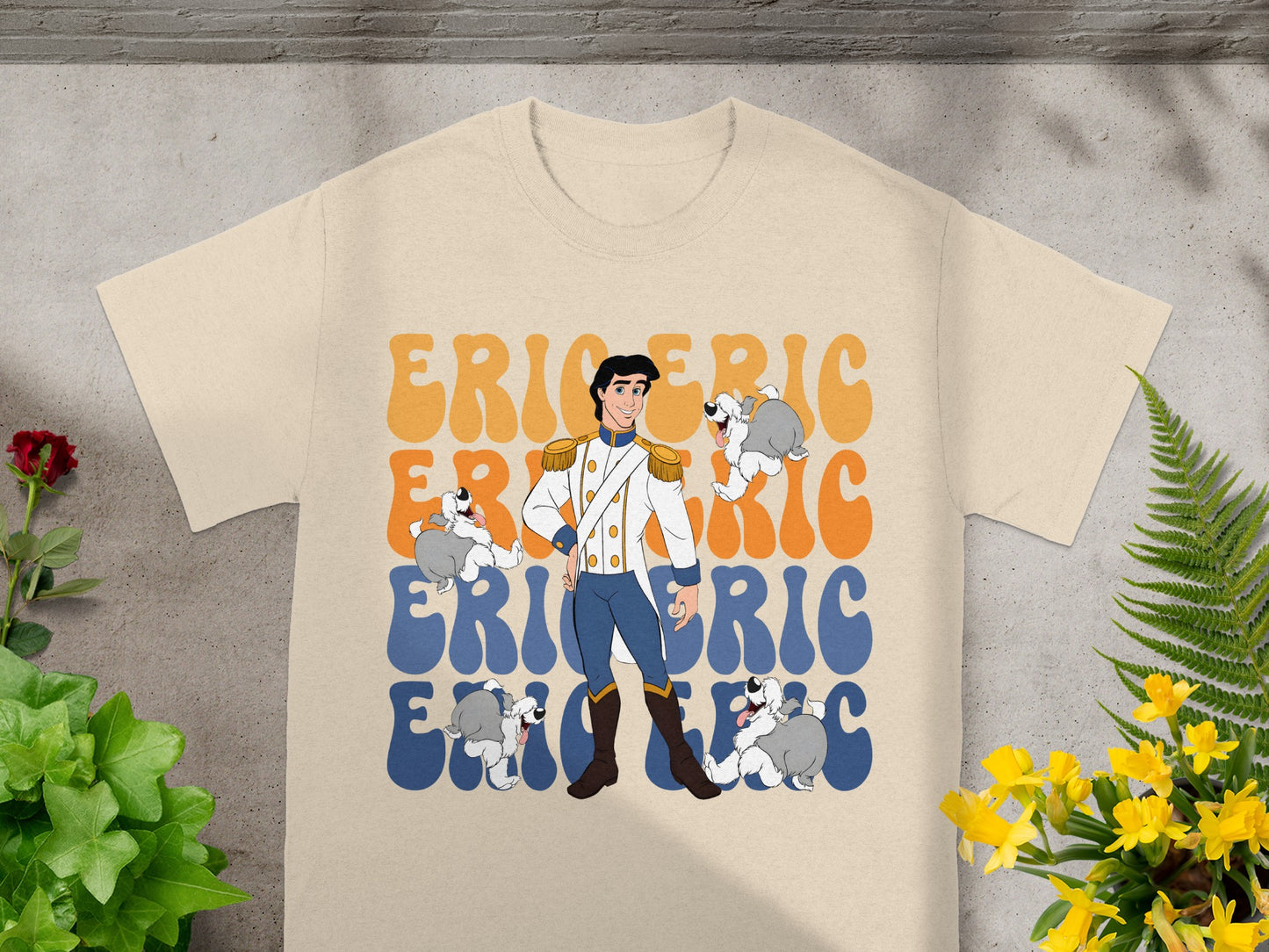 Prince Eric with two dogs on a tan t-shirt.