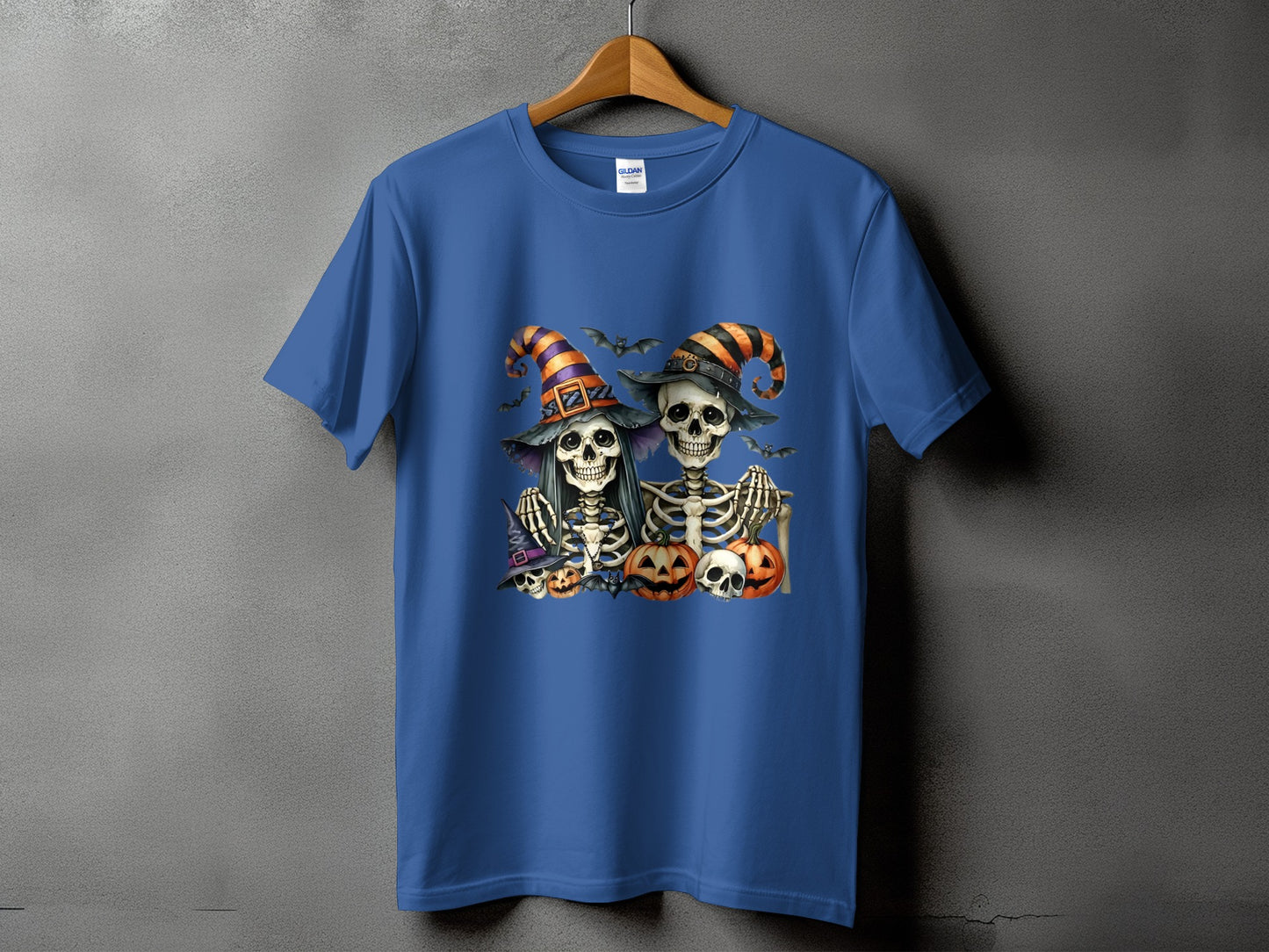 Two skeletons wearing witch hats with pumpkins and bats.