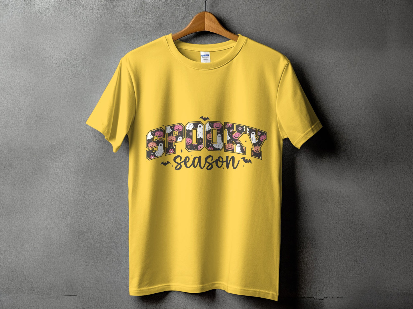 Yellow t-shirt with "SPOOKY season" text featuring Halloween motifs.