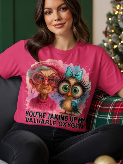 Woman wearing pink t-shirt with cartoon owl and text "YOU'RE TAKING UP MY VALUABLE OXYGEN".