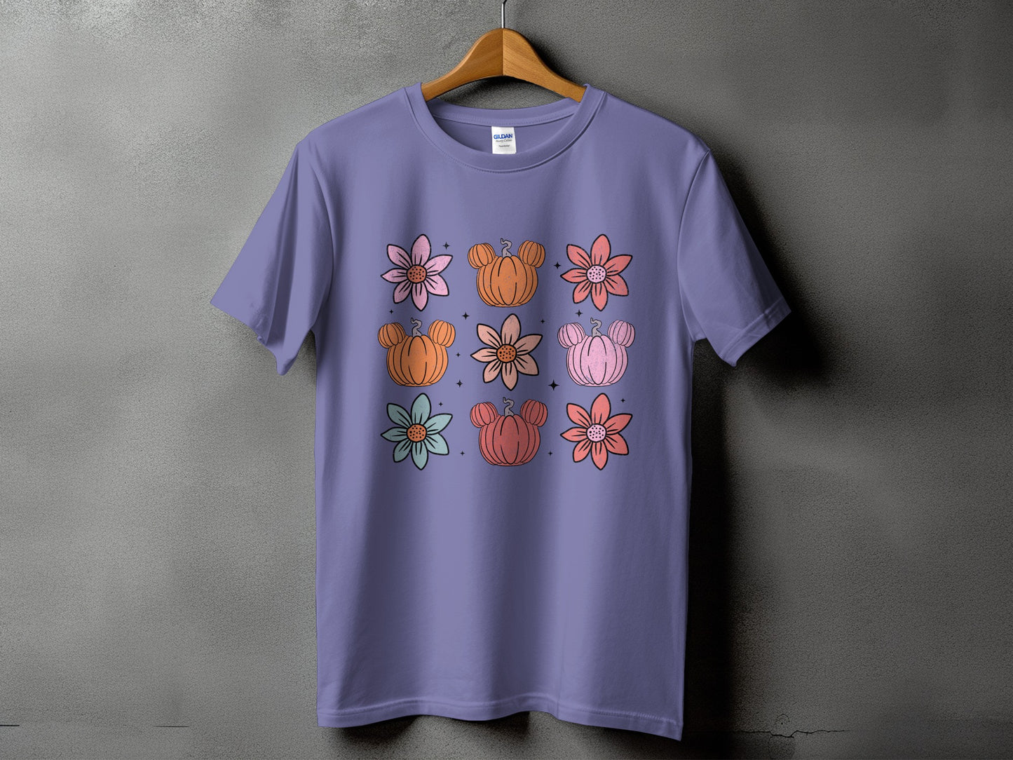 Purple t-shirt with a grid of cartoon flowers and Mickey-shaped pumpkins.