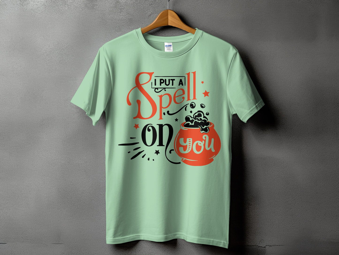 Mint t-shirt with "I put a spell on you" and cauldron graphic.