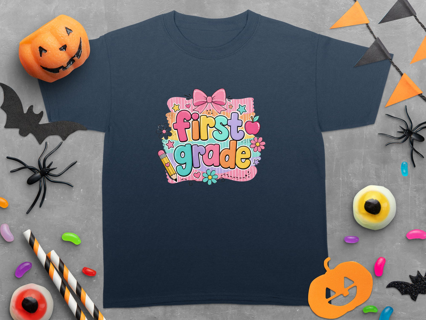 Navy t-shirt with colorful "first grade" graphic and Halloween decor.