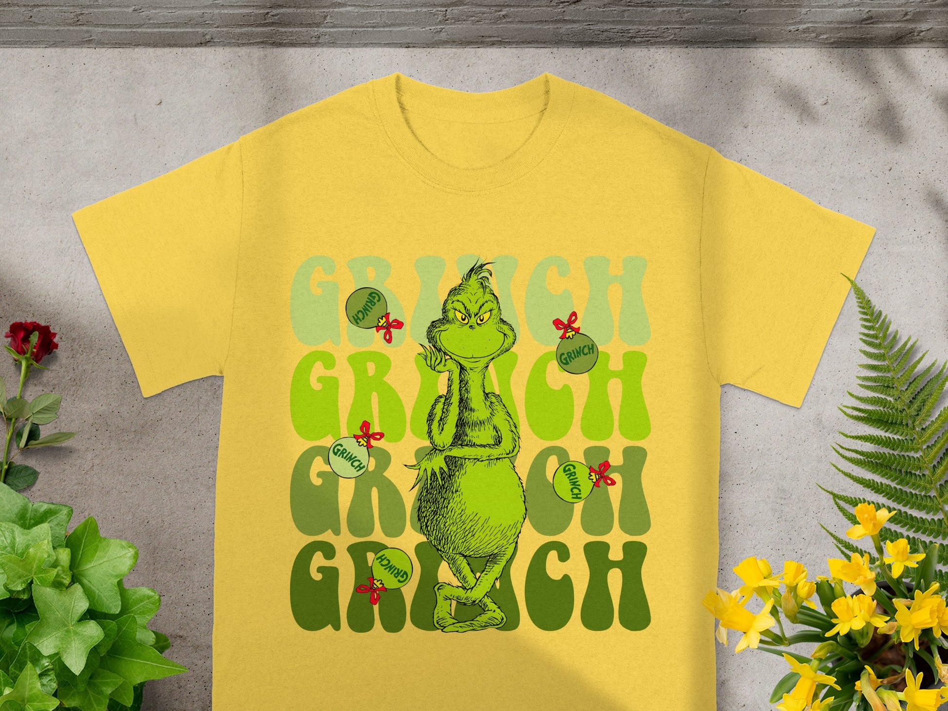 Yellow t-shirt with a distressed Grinch graphic in green and red.