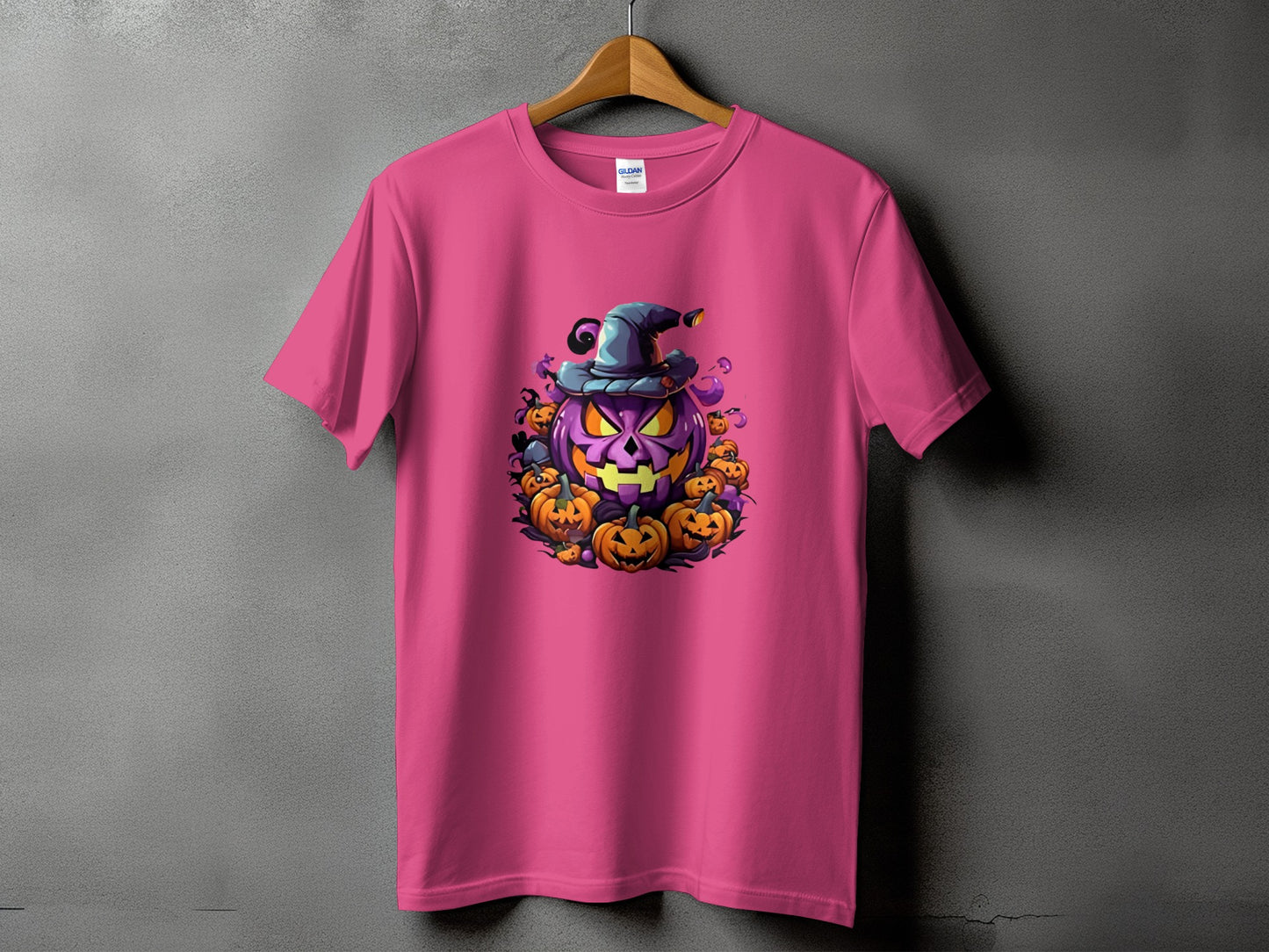 Pink t-shirt with a cartoon Halloween pumpkin wearing a witch hat.