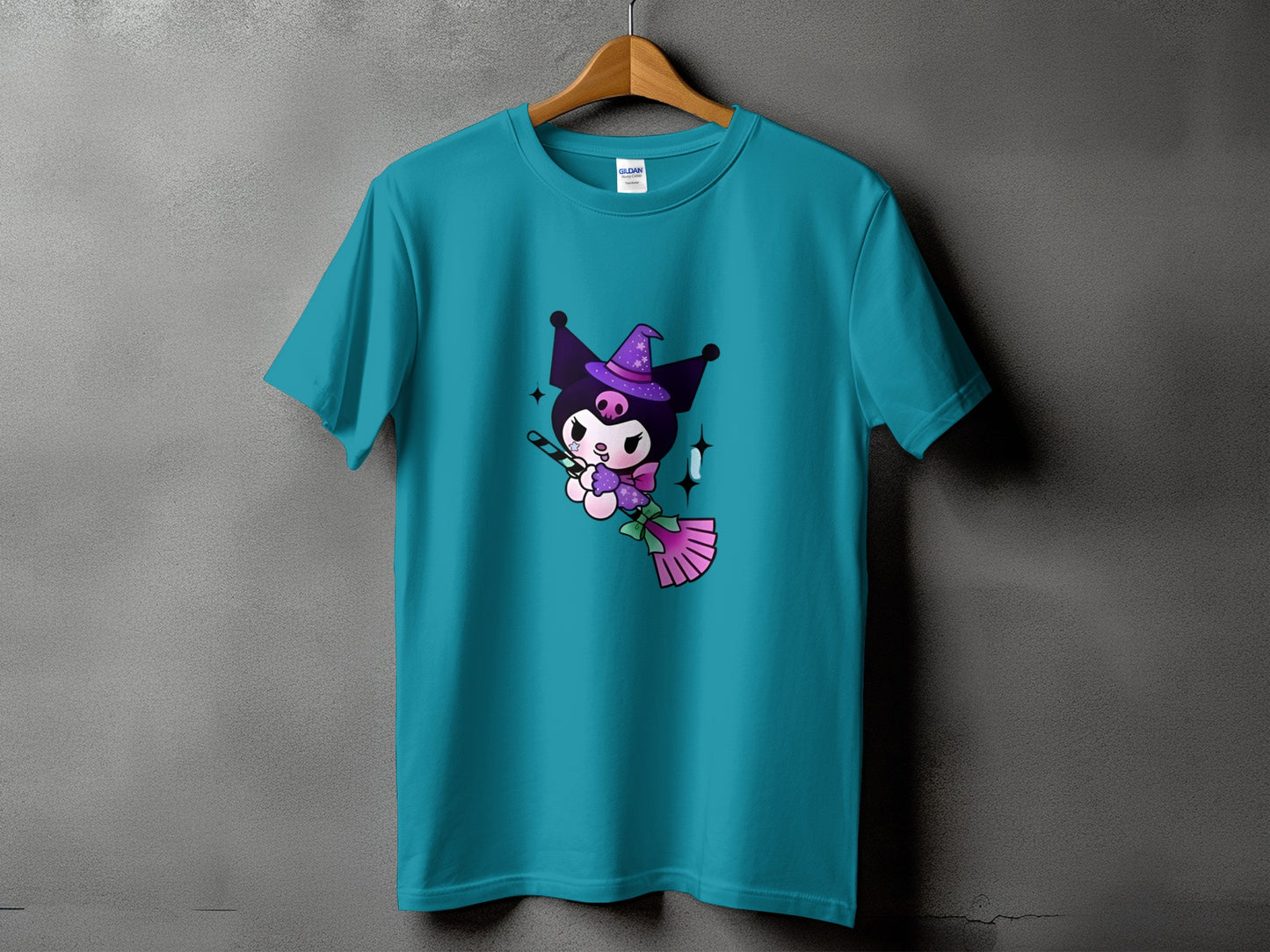 Teal t-shirt with Kuromi riding a broomstick, holding a candy cane.
