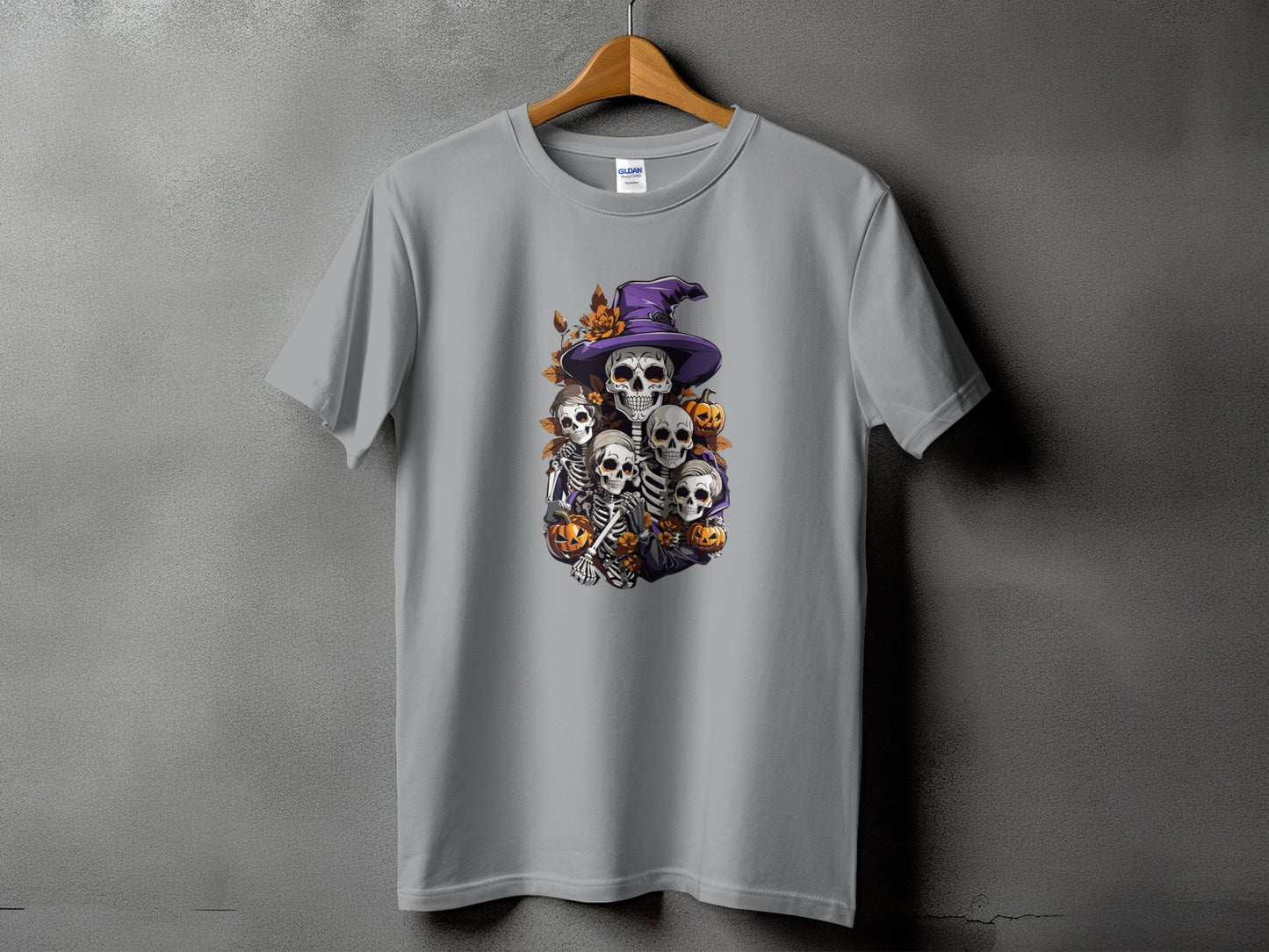 Grey t-shirt with Halloween skeleton graphic wearing a purple witch hat and pumpkins.