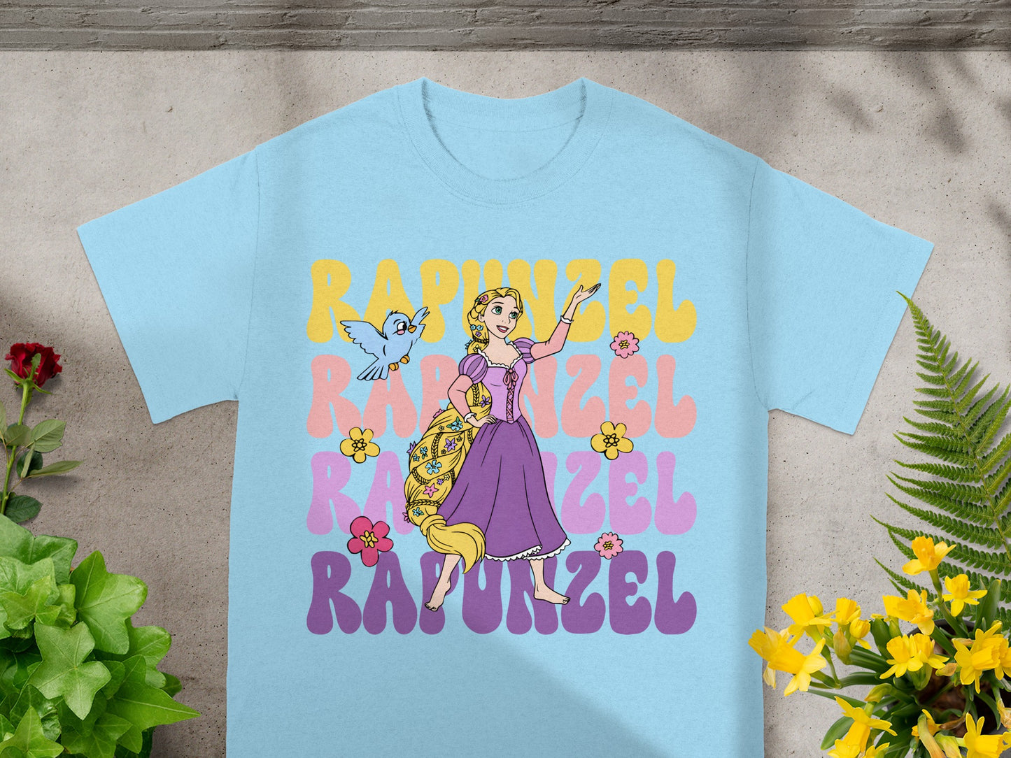 Light blue t-shirt with Rapunzel and Pascal from Disney's Tangled.