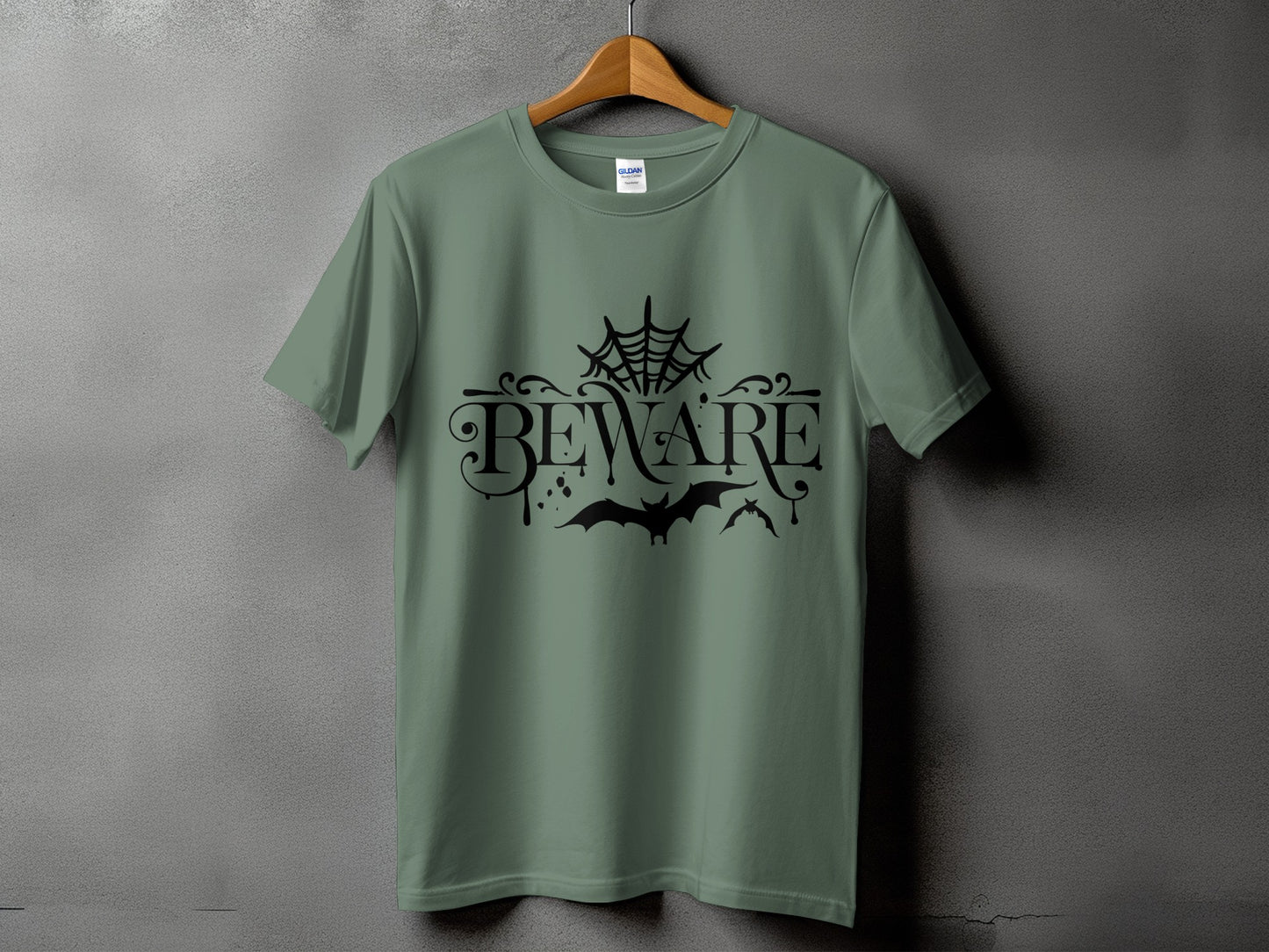 Green t-shirt with black "Beware" text, spiderweb, and bats graphic.