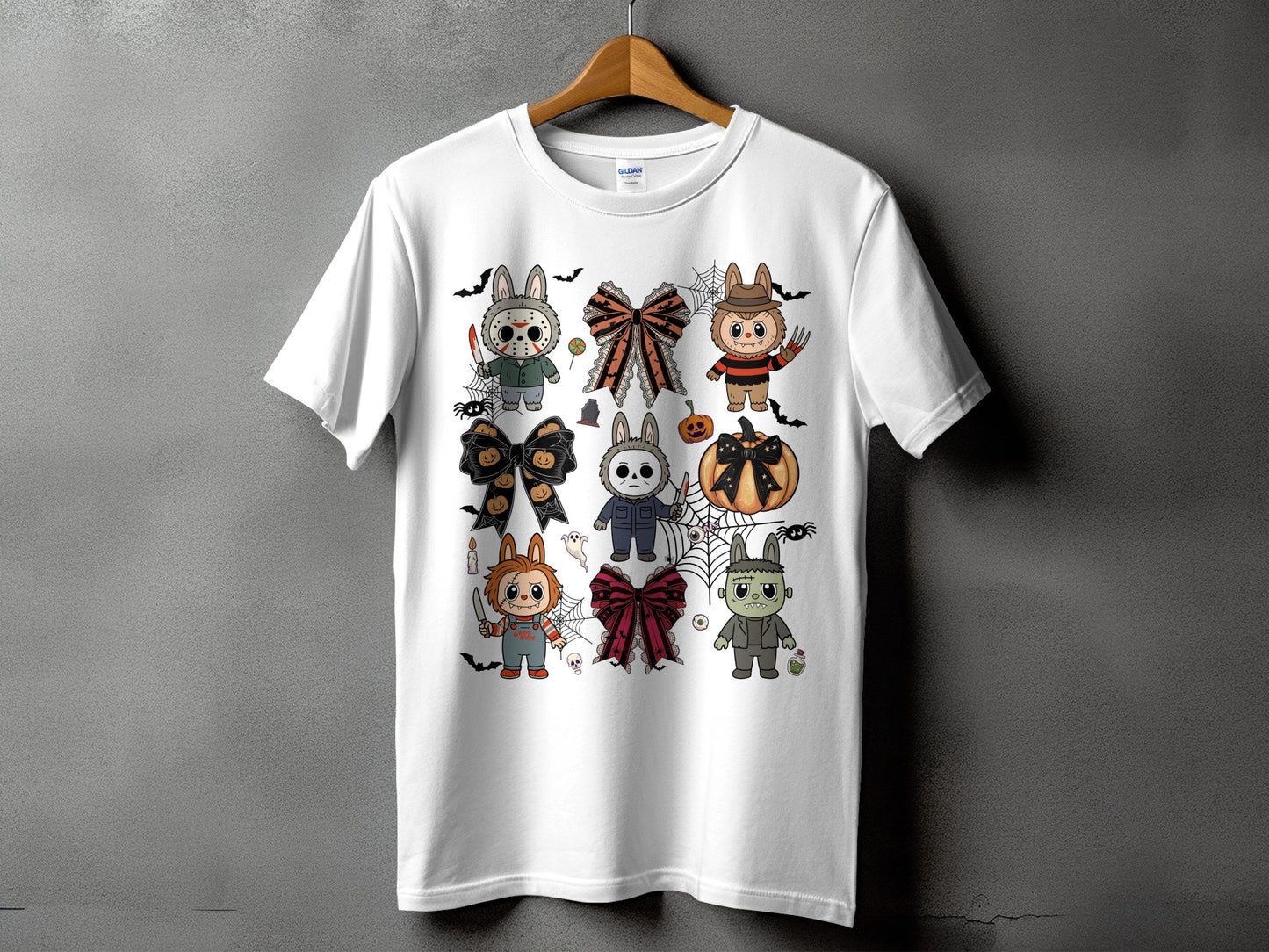 White t-shirt with a Halloween graphic featuring cartoon horror characters and bows.