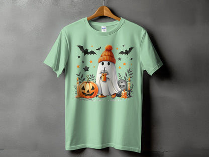 Ghost in beanie holding drink with pumpkin, bats, RIP tombstone, and candles.