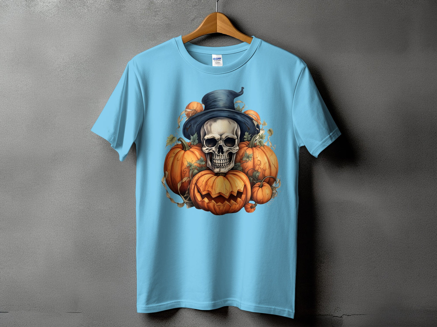 Light blue t-shirt with a skull in a witch hat surrounded by carved pumpkins.