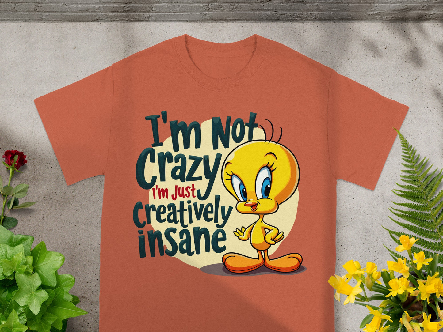 Orange t-shirt with Tweety Bird saying "I'm Not Crazy I'm Just Creatively Insane".