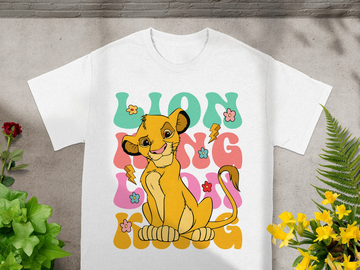 White t-shirt with Simba from The Lion King and "Lion King" text.