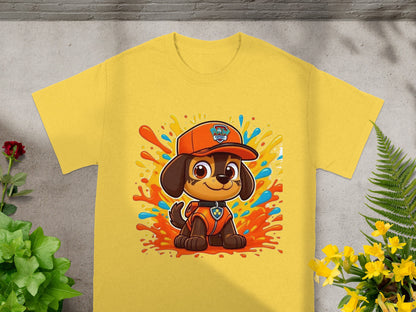 Chase from Paw Patrol on a yellow t-shirt with orange splash graphics.