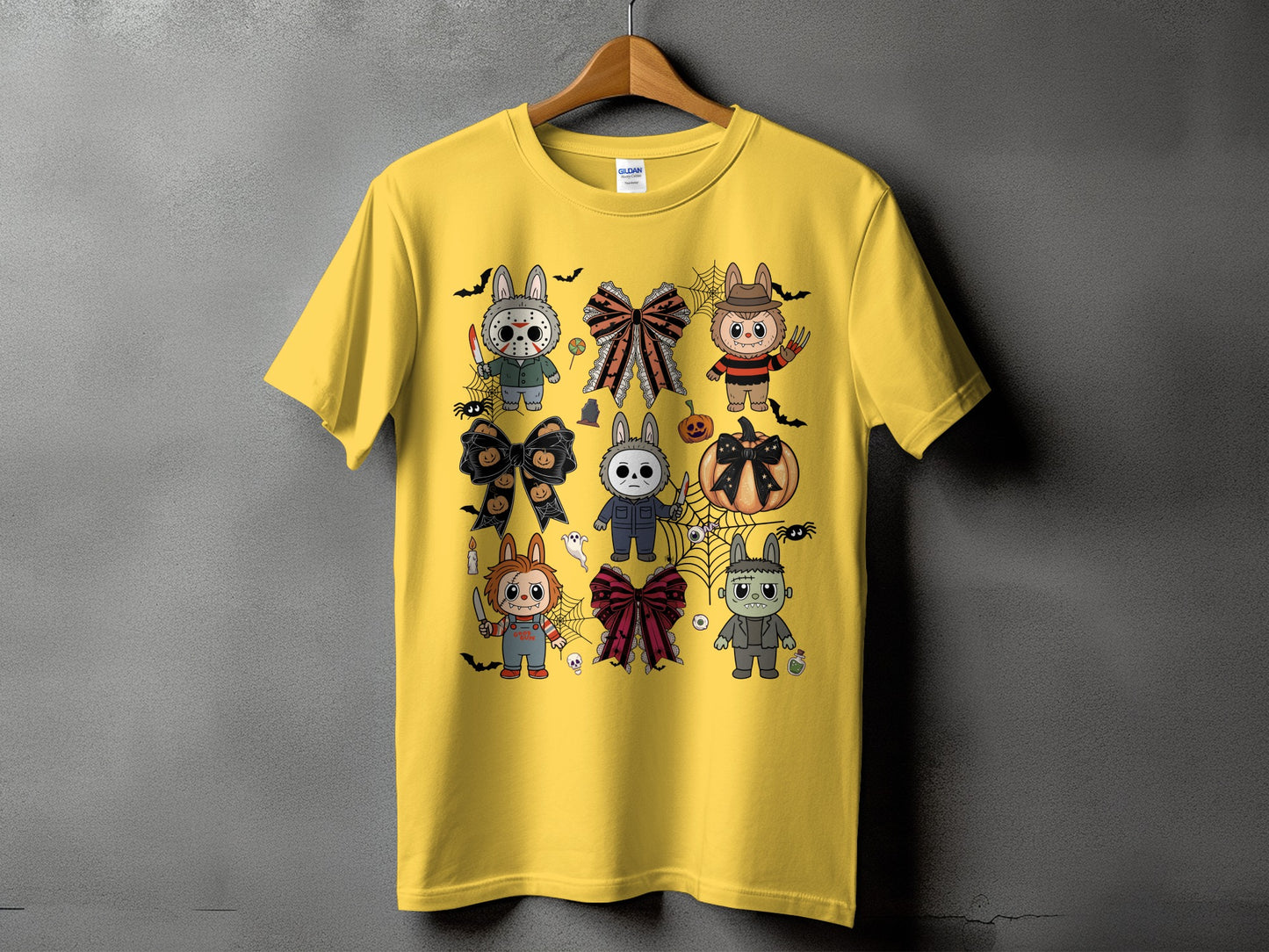 Yellow t-shirt with cartoon Halloween characters and bows.