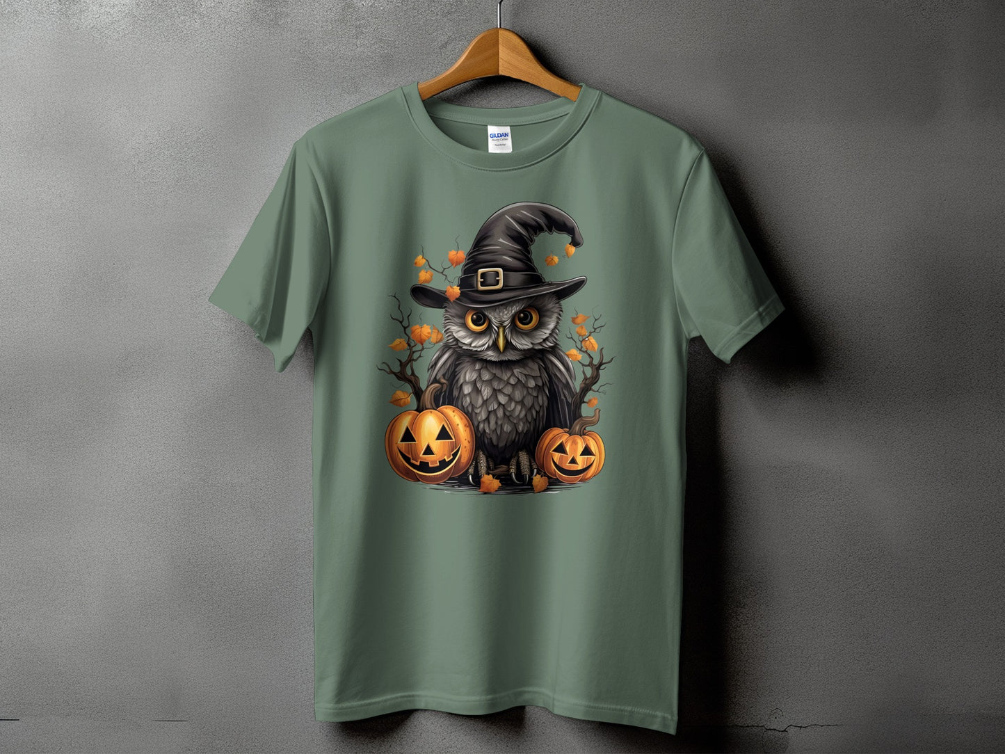 Green t-shirt with an owl in a witch hat and pumpkins graphic.